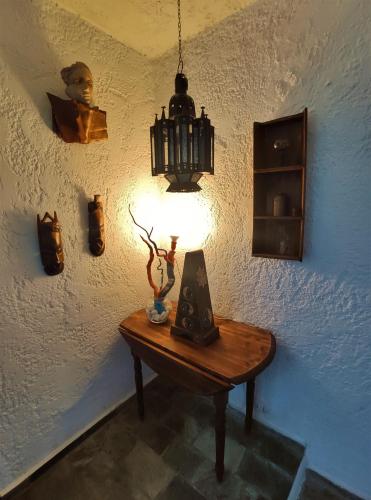 a table in a room with a lamp on it at I GABBIANI in Pefkohori