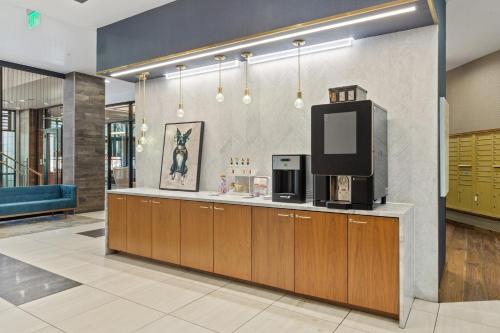 a lobby with a counter with a tv on it at Kasa Union Station Denver in Denver