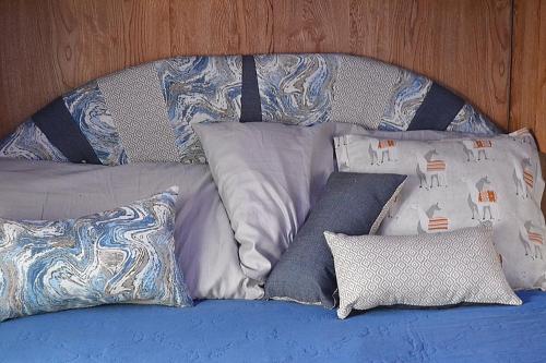 a bed with a bunch of pillows on it at The blue rooster 