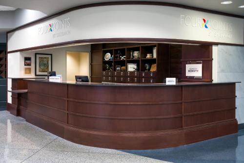 a lobby of a hotel with a reception counter at Four Points Huntsville Airport in Madison
