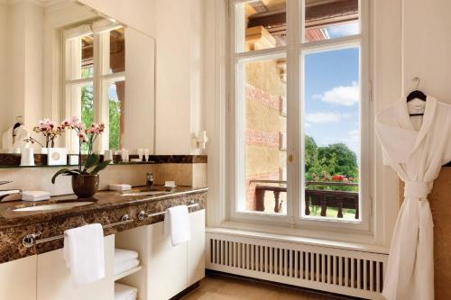 a bathroom with a sink and a window at Villa Rothschild, Autograph Collection in Königstein im Taunus