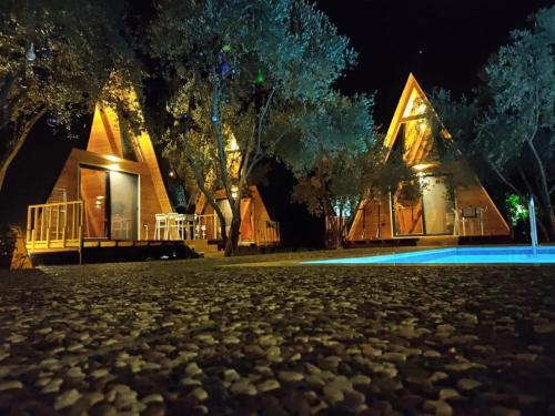 a house at night with a cobblestone yard at GÖCEK BUNGALOW in Göcek