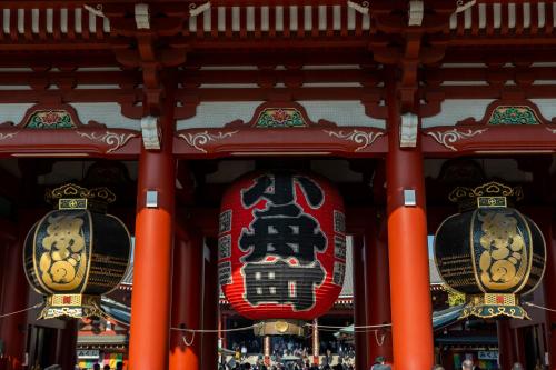 a temple with two red columns and a sign at KOKO HOTEL Residence Asakusa Kappabashi in Tokyo