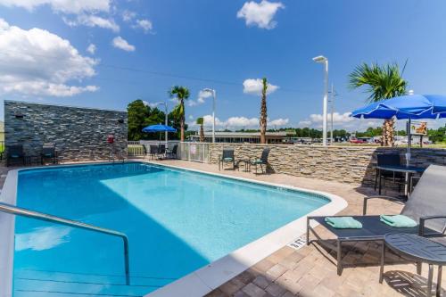 a pool with chairs and umbrellas at a hotel at Fairfield Inn & Suites by Marriott Panama City Beach in Panama City Beach