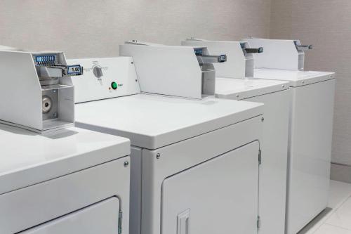 a row of white washing machines in a room at Fairfield Inn & Suites by Marriott New York Manhattan/Times Square South in New York