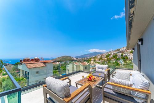 a balcony with chairs and a view of the ocean at Villa Kazarman, Kalkan’ın kalbinde denize, merkeze in Kalkan