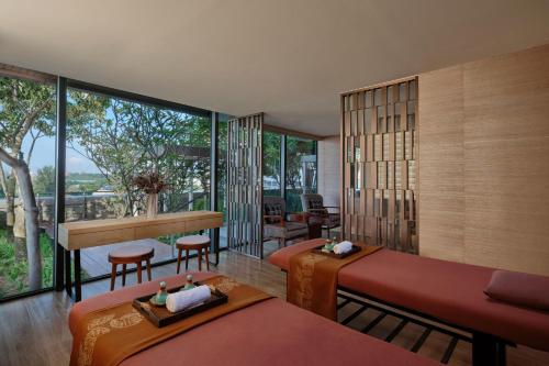 a hotel room with two beds and a balcony at Batam Marriott Hotel Harbour Bay in Nagoya