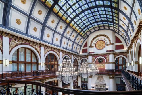 an ornate building with a glass ceiling and chandeliers at The Union Station Nashville Yards, Autograph Collection in Nashville