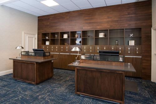 an office with two reception desks and wooden walls at Four Points by Sheraton Eastham Cape Cod in Eastham