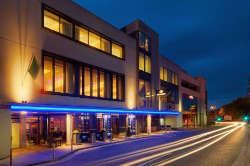 a building on the side of a street at night at Sheraton Athlone Hotel in Athlone