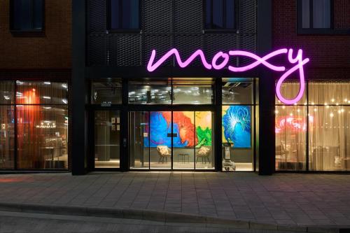 a neon sign in the window of a store at Moxy Bristol in Bristol
