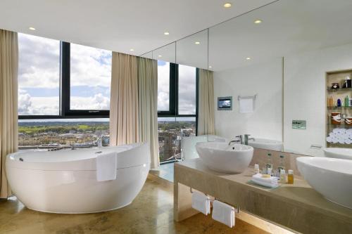 a large bathroom with two sinks and a large mirror at Sheraton Athlone Hotel in Athlone