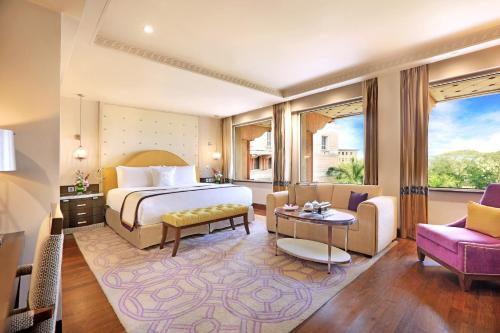 a bedroom with a bed and a living room at ITC Maratha, a Luxury Collection Hotel, Mumbai in Mumbai