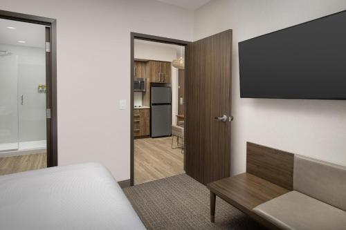 a living room with a couch and a flat screen tv at Element Seattle Sea-Tac Airport in Tukwila