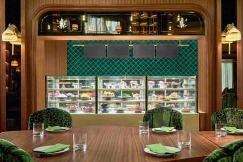 a dining room with a table and chairs and a refrigerator at Maxwell Reserve Singapore, Autograph Collection in Singapore