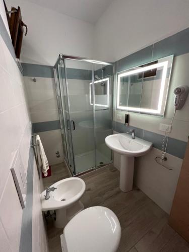 a bathroom with a toilet and a sink and a shower at Villa Latino in Vieste