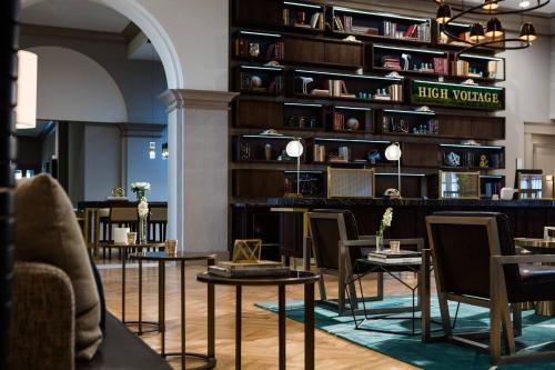 a room with tables and chairs in a library at Renaissance Waterford Oklahoma City Hotel in Oklahoma City