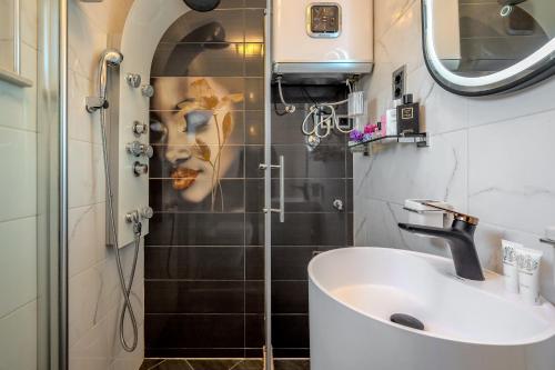 a bathroom with a sink and a shower at Uniquely designed Villa Ivana with outdoor Jacuzzi nearby the pebble Banje beach at the Island of Solta in Rogač