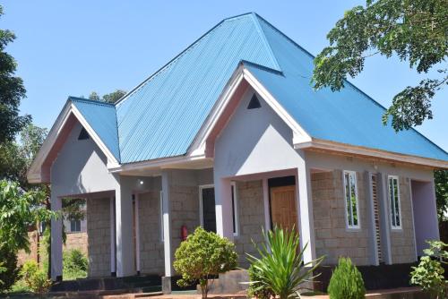 a house with a blue roof at Kili View Lodge in Moshi