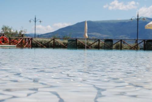 a body of water with a pier in the background at Tenuta Del Perugino in Bettona