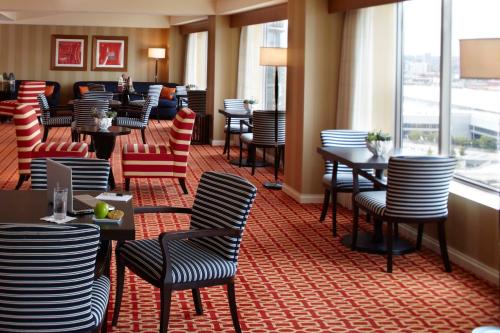 a restaurant with chairs and tables in a room at Renaissance Boston Waterfront Hotel in Boston