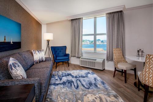 a living room with a couch and a table at Sheraton Portsmouth Harborside Hotel in Portsmouth