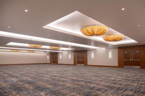 a large room with a large ballroom with lights on the ceiling at JW Marriott Los Angeles L.A. LIVE in Los Angeles