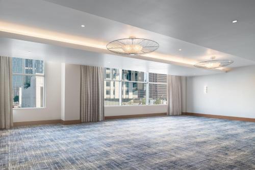 a large room with two windows and a large rug at JW Marriott Los Angeles L.A. LIVE in Los Angeles