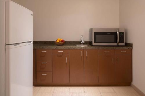 a kitchen with a refrigerator and a microwave at JW Marriott Los Angeles L.A. LIVE in Los Angeles