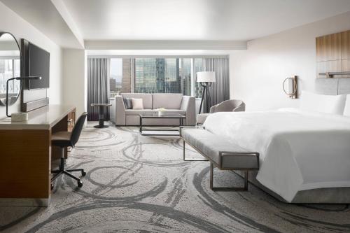 a hotel room with a bed and a living room at JW Marriott Los Angeles L.A. LIVE in Los Angeles