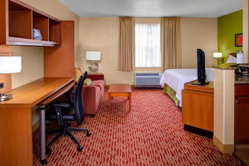 a hotel room with a bed and a desk with a computer at Towneplace Suites by Marriott Cleveland Westlake in Westlake