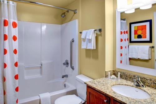 a bathroom with a shower toilet and a sink at Towneplace Suites by Marriott Cleveland Westlake in Westlake