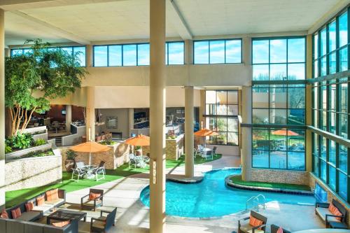 an indoor pool in a building with windows at Sheraton Charlotte Airport in Charlotte