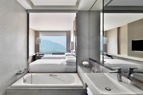 a bathroom with two sinks and a large mirror at Kathmandu Marriott Hotel in Kathmandu