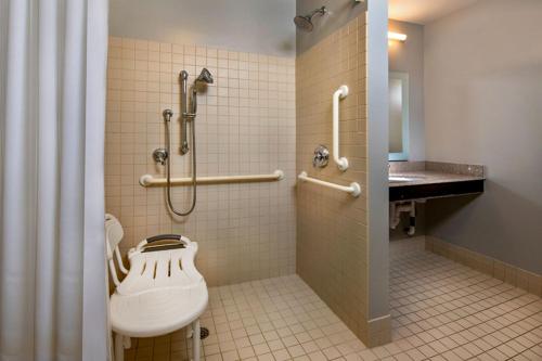 a bathroom with a shower and a toilet and a sink at TownePlace Suites by Marriott Frederick in Frederick
