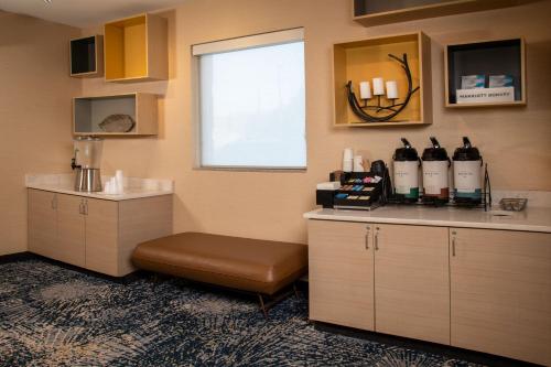 a room with a counter with bottles of wine at TownePlace Suites by Marriott Frederick in Frederick