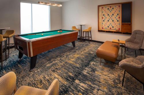 a billiard room with a pool table and chairs at TownePlace Suites by Marriott Frederick in Frederick