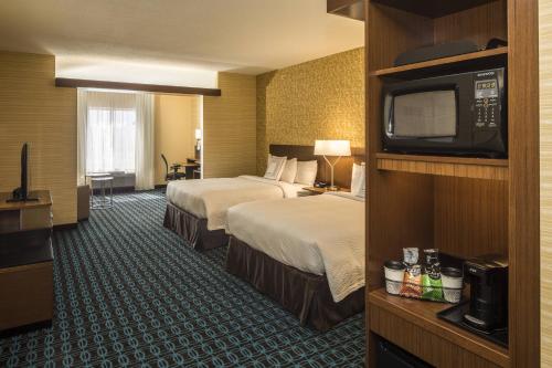 a hotel room with two beds and a flat screen tv at Fairfield Inn & Suites by Marriott Pittsburgh North/McCandless Crossing in McCandless Township