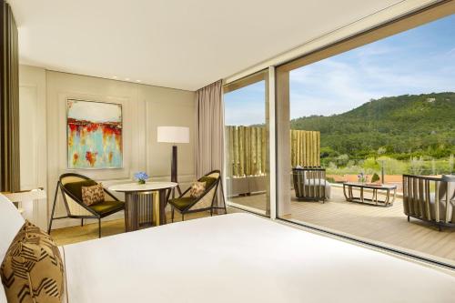 a hotel room with a bed and a large window at Penha Longa Resort in Sintra