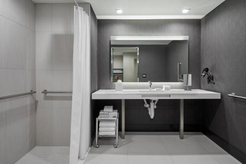 a bathroom with a sink and a mirror at AC Hotel by Marriott Durham in Durham