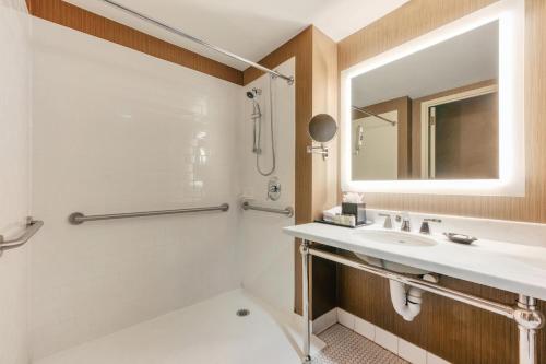 a bathroom with a sink and a mirror at Sheraton Tarrytown Hotel in Tarrytown