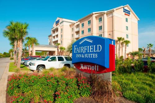 a sign for a hotel in front of a building at Fairfield Inn & Suites Orange Beach in Orange Beach