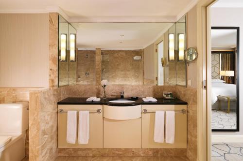 a bathroom with a sink and a shower at Sheraton Grand Warsaw in Warsaw