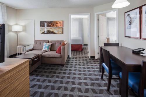 a living room with a couch and a table at TownePlace Suites Minneapolis Eden Prairie in Eden Prairie