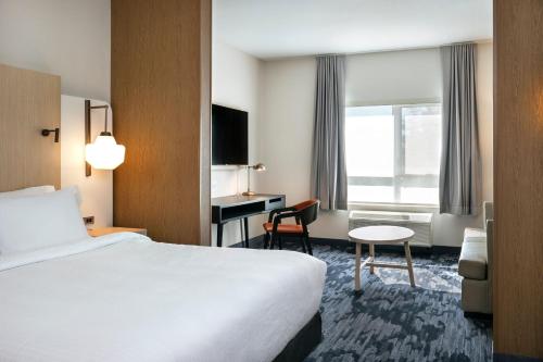Cette chambre comprend un lit et un bureau. dans l'établissement Fairfield by Marriott Inn & Suites North Bay, à North Bay