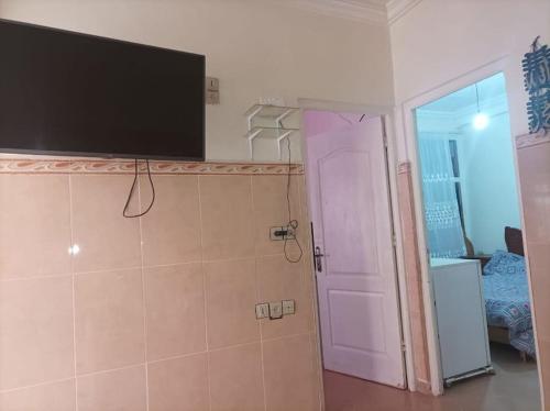 a room with a flat screen tv on a wall at Maison Latifa in Oujda