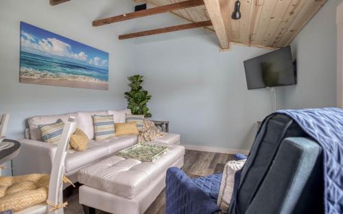 a living room with a couch and a tv at Driftwood in Rockaway Beach