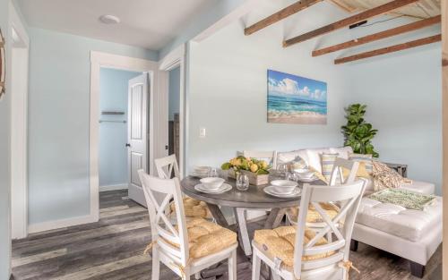 a dining room with a table and chairs and a couch at Driftwood in Rockaway Beach
