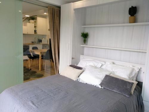 a bedroom with a bed with white pillows at Casa Rocha Velha con piscina y terraza particular in Santiago de Compostela