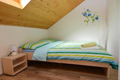 a bedroom with a bed and a wooden ceiling at Apartments with a parking space Pavicini, Marcana - 21315 in Pavicini